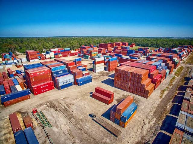 Shipping containers stored across a yard